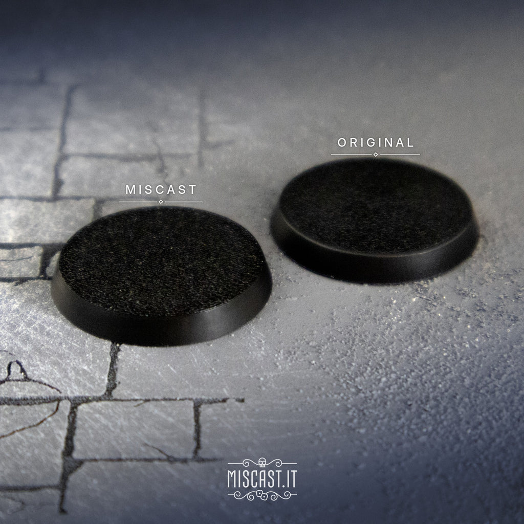 Miscast and original 32 mm round bases side by side, three-quarter view